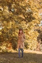 Colorful foliage in the park. Falling leaves natural background. ginger girl in nature Royalty Free Stock Photo