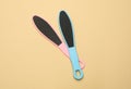 Colorful foot files on beige background, flat lay. Pedicure tools