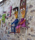 Colorful frames hanging on the wall. Flowerpots placed in the frame. They have evil eye beads. It was taken on the island of Cunda