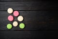 Colorful french macarons, on black wooden table background, top view flat lay, with copy space for text Royalty Free Stock Photo