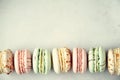 Colorful french macaroons flat lay. Pastel colors pink, green, yellow macarons with copy space, top view. Holidays and Royalty Free Stock Photo