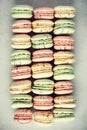 Colorful french macaroons flat lay. Pastel colors pink, green, yellow macarons with copy space, top view. Holidays and Royalty Free Stock Photo