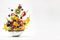 Colorful fresh fruit salad in a white plate, fruits flying in the air, levitation on a white background. Royalty Free Stock Photo