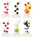 Colorful fresh fruits falling into the milky splash.
