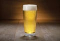 A colorful fresh pint glass of pale ale beer, pilsner, lager, traditional brew on wooden background Royalty Free Stock Photo