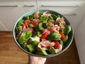 colorful fresh salad, pesto, basil leaves, small tomatoes, cucumber, mozzarella Royalty Free Stock Photo