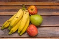 Colorful fresh summer fruits on brown wooden background, healthy organic food on table, detox vitamin nutrition for health care. Royalty Free Stock Photo