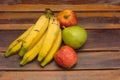 Colorful fresh summer fruits on brown wooden background, healthy organic food on table, detox vitamin nutrition for health care. Royalty Free Stock Photo