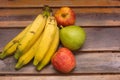 Colorful fresh summer fruits on brown wooden background, healthy organic food on table, detox vitamin nutrition for health care. Royalty Free Stock Photo