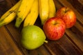 Colorful fresh summer fruits on brown wooden background, healthy organic food on table, detox vitamin nutrition for health care. Royalty Free Stock Photo