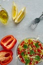 Colorful fresh vegetable salad in a glass bowl on a grey wooden table. Vegetarian salad of cabbage, sweet pepper and Royalty Free Stock Photo