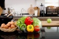 Colorful fresh vegetables salad in a glass cup and food ingredients on table counter kitchen with blurred background of beautiful Royalty Free Stock Photo