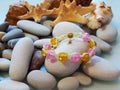 Colorful friendship bracelet on sea pebble