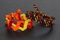 Colorful friendship bracelets with fiery colors handmade of embroidery bright floss and thread with knots isolated on black backgr