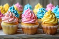 Colorful frosted cupcakes with sprinkles. Ideal image