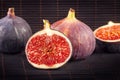 Colorful fruit background - four great figs on a dark wooden background