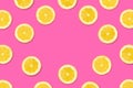 Fruit frame of lemon slices on a pastel pink background