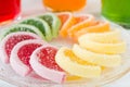 Colorful fruit jelly candies arranged in circle on wooden table. Royalty Free Stock Photo