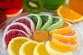 Colorful fruit jelly candies arranged in circle on wooden table. Royalty Free Stock Photo