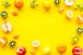 Colorful fruit mockup. Cut apple, kiwi, citrus on yellow background top-down copy space Royalty Free Stock Photo