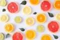 Colorful fruit pattern of citrus slices and leaves, top view over a white background Royalty Free Stock Photo