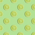 Colorful fruit pattern of fresh lime slices on green background Royalty Free Stock Photo