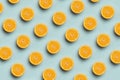 Colorful fruit pattern of fresh orange slices on blue background. Top view oranges.