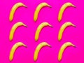 Colorful fruit pattern of fresh yellow bananas on a pink background Royalty Free Stock Photo