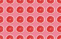 Colorful fruit pattern of grapefruit slices on pink background. Royalty Free Stock Photo