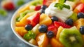 A colorful fruit salad topped with a dollop of creamy custard, a refreshing dessert Royalty Free Stock Photo