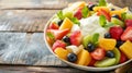 A colorful fruit salad topped with a dollop of creamy custard, a refreshing dessert Royalty Free Stock Photo