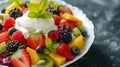 A colorful fruit salad topped with a dollop of creamy custard, a refreshing dessert Royalty Free Stock Photo