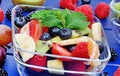 Colorful fruit salad in a transparent bowl on table Royalty Free Stock Photo