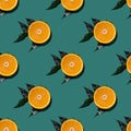 Colorful fruit seamless pattern of halves of oranges with green leaves isolated on green background. Top view Royalty Free Stock Photo