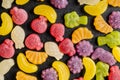 Colorful fruity jelly candies on black table