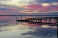 Sunset and Reflection in the Bay with a Pier Royalty Free Stock Photo