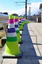 Colorful funnel, traffic rubber cone on community road for caution and accident prevention Royalty Free Stock Photo