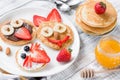 Colorful and funny breakfast for kids. Animal shaped pancakes on white plate Royalty Free Stock Photo