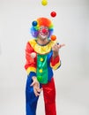 Colorful funny clown juggling balls Royalty Free Stock Photo