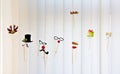 Colorful funny hats, horns and glasses dance on the blinds