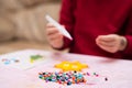 Colorful fusible beads or perler beads, on the children`s table. Toy that develops the imagination of child. Soft blurred