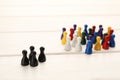 Colorful game pieces on white wooden table. Racism concept Royalty Free Stock Photo