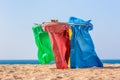 Colorful garbage bags on beach at coast