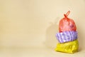 Colorful garbage bags on yellow background