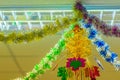 Colorful garlands are hanging on the ceiling at the office to decoration prepare for Christmas and new year party cerebration.