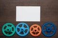 Colorful gears on the brown wooden background