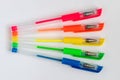 Colorful gel neon pens on white background.