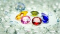 .colorful gems displayed in the middle of a white diamonds.