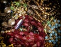 Colorful gems and golden fashion jewels closeup, top view Royalty Free Stock Photo