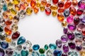 Colorful gems on white. Colorful Sapphires, ruby, amethyst, topaz, emerald gemstones scattered on a white background with empty Royalty Free Stock Photo